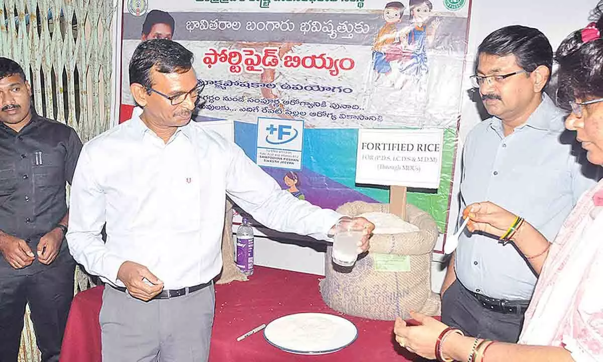 District Collector P Koteswara Rao and others during an awareness meeting on the fortified rice in Kurnool on Monday