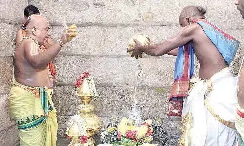 Priest performing Ksheeradhivasam ritual as part of Maha Samprokshanam in Vakulamatha temple at Pathakaluva village near Tirupati on Monday