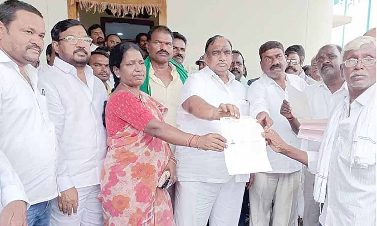 MLA V Sathish Kumar handing over CMRF cheques to people at Husnabad in Karimnagar district on Tuesday