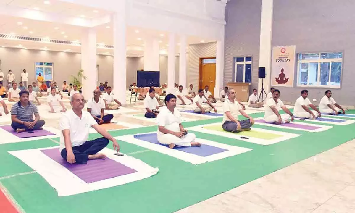 Vijayawada railway division staff participating in Yoga Day programme at railway function hall in Vijayawada on Tuesday