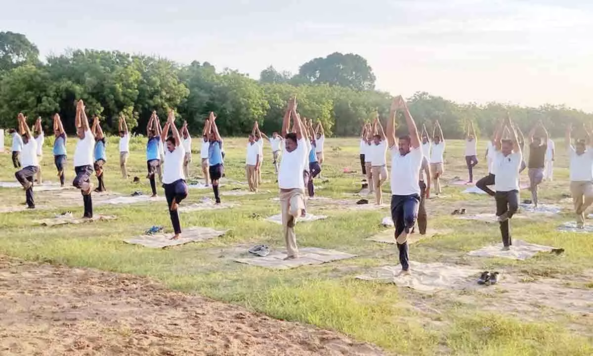Police officials practising yoga at DPO in Bapatla on Tuesday