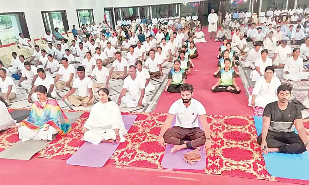 District Collector Dr K Madhavi Latha, MP M Bharat Ram, RUDA Chairperson M Sharmila Reddy, Municipal Commissioner K Dinesh Kumar and others participating in the Yoga Day event in Rajamahendravaram on Tuesday