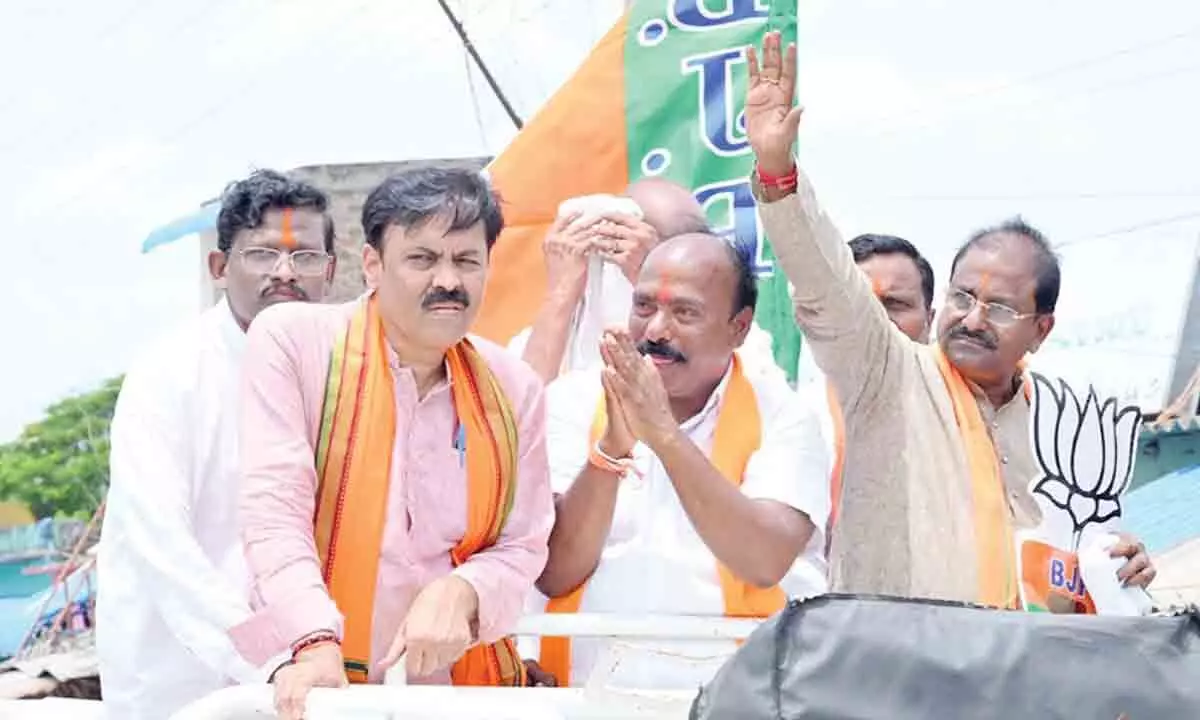 BJP state president Somu Veerraju, Rajya Sabha member G V L Narasimha Rao and other leaders along with party candidate G Bharat Kumar Yadav in a road show in Atmakur on Tuesday