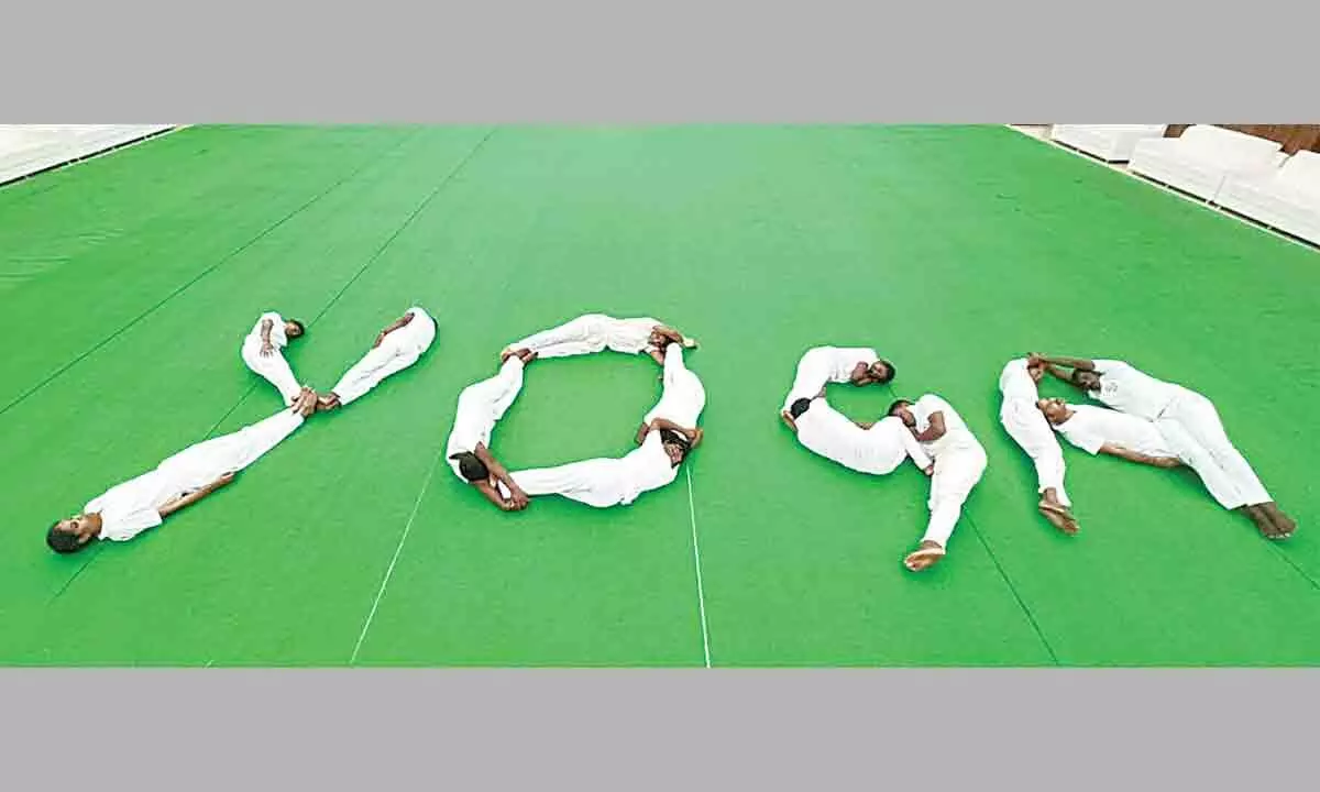 Adikavi Nannaya University students performing Yoga at the university convention centre in Rajamahendravaram on Tuesday