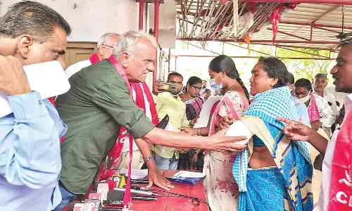 CPI national secretary K Narayana enquiring with a woman about her injury at Gundla Singaram near Hanumakonda on Wednesday
