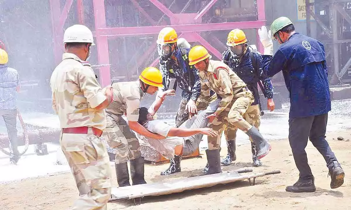 CISF team rescuing an injured person as a part of the mock drill exercise at Visakhapatnam Steel Plant in Visakhapatnam on Thursday