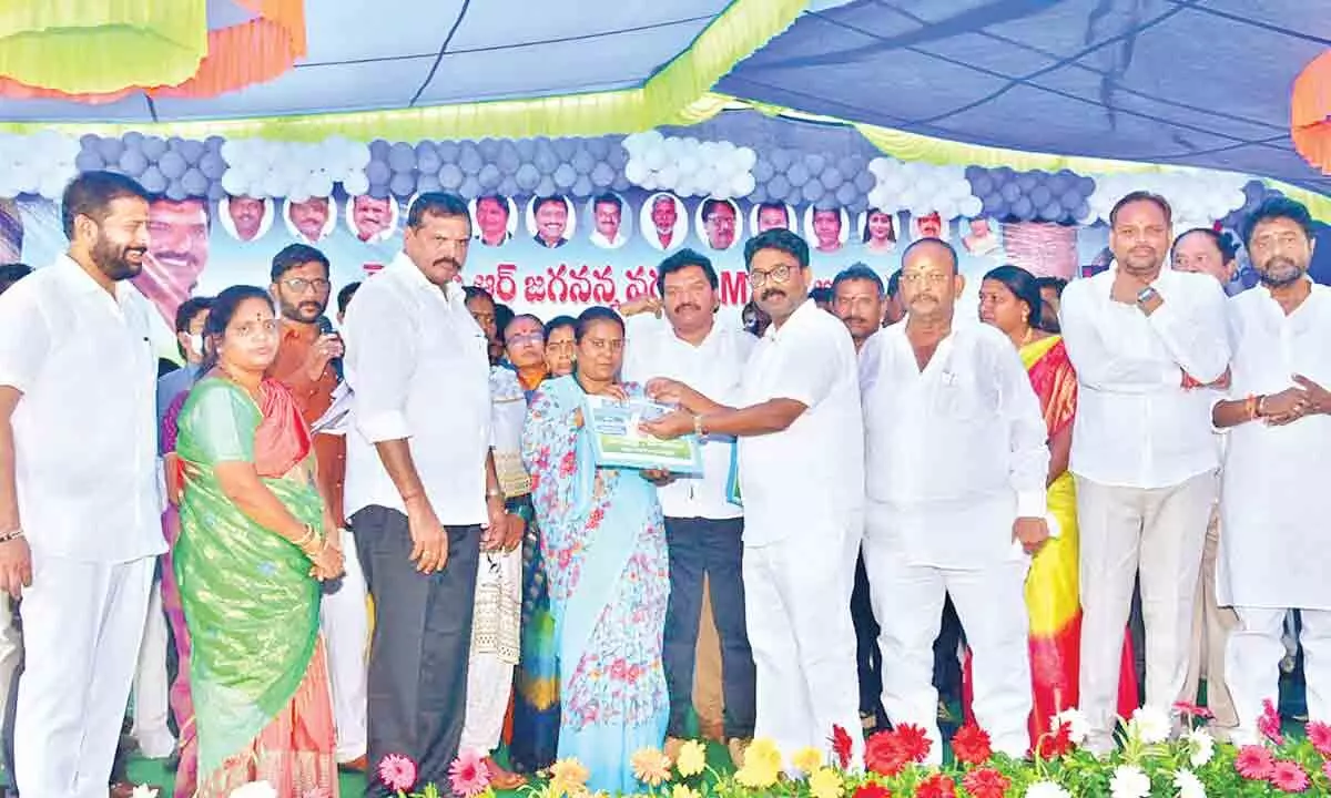 Ministers Botcha, Suresh handing over documents and keys to beneficiaries in Vizianagaram on Thursday
