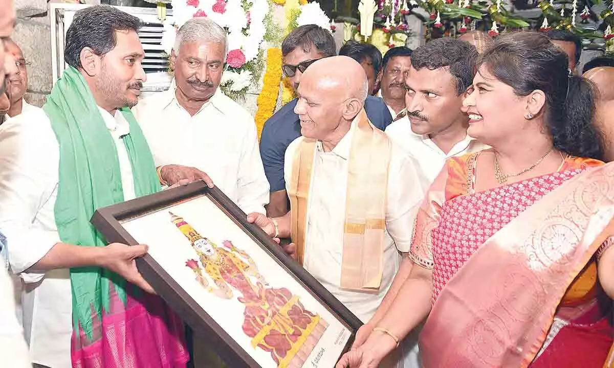 TTD EO AV Dharma Reddy presenting Sri Padmavathi Devi portrait made of dry flower technology to Chief Minister YS Jagan Mohan Reddy at Vakulamatha temple on Thursday. Minister for Energy Peddireddi Ramachandra Reddy is also seen
