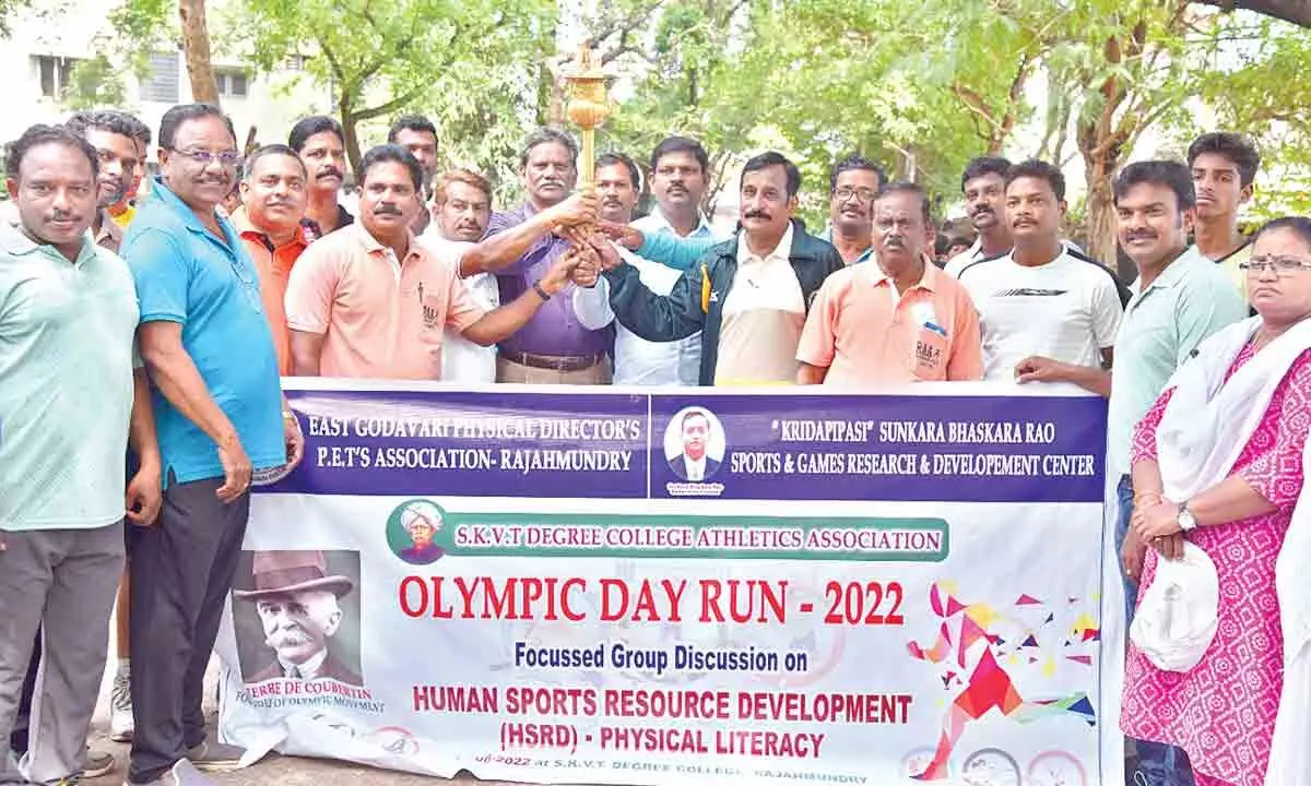DEO S Abraham, Sports Researcher Sunkara Nagendra Kishore, SKVT College Principal Abel Raju and others participating in the Olympic Day run in Rajamahendravaram on Thursday