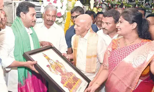TTD EO AV Dharma Reddy presenting Sri Padmavathi Devi portrait made of dry flower technology to Chief Minister YS Jagan Mohan Reddy at Vakulamatha temple on Thursday. Minister for Energy Peddireddi Ramachandra Reddy is also seen