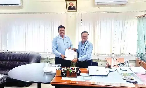 M Raja Kishore (left) taking charge as Tirupati Airport Director from In-charge Director Basavaraju on Thursday