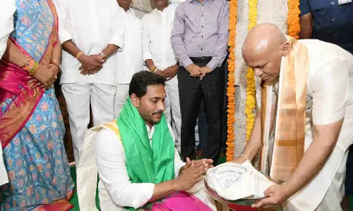 TTD EO A V Dharma Reddy presents theertha prasadams to Chief Minister Y S Jagan Mohan Reddy during the Maha Samprokshanam at Vakulamatha temple on Thursday
