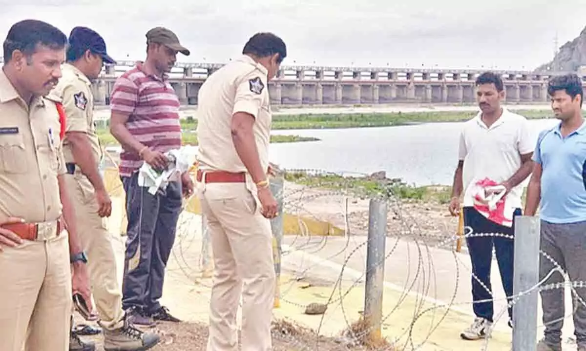 Police constables setting up iron fencing at Pushkara ghat at Tadepalli on Friday