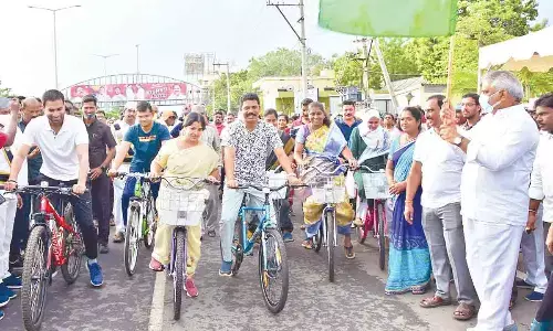 NTR district collector S Dilli Rao, mayor Bhagyalakshmi, municipal commissioner Swapnil Dinkar and others take part in bicycle rally in Vijayawada on Saturday