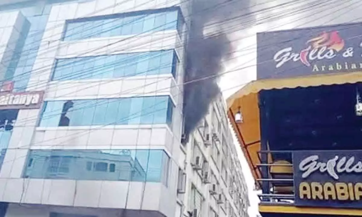 Smoke coming from the building of Sri Chaitanya College on MG Road in Vijayawada on Monday