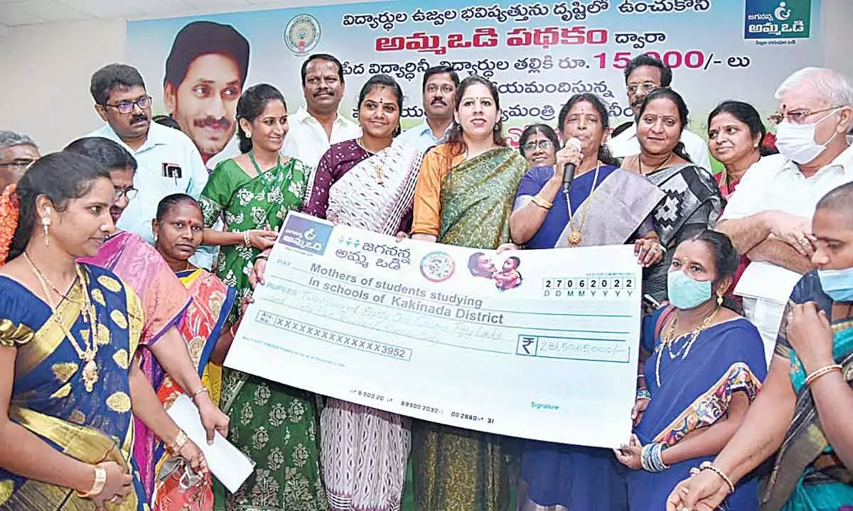 District Collector Kritika Shukla and MP Vanga Geetha distributing Amma Vodi benefits to poor mothers at a programme in Kakinada on Monday