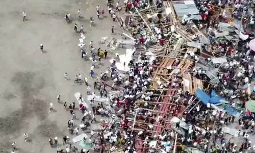 Spectators are sent plunging to the ground as part of a wooden stand collapses during a bullfight at a stadium in the city of El Espinal. (Photo | AP)