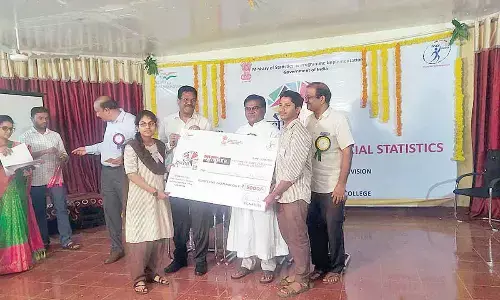 Rector Rev Fr Bala Showry, Dr Nunna Srinivasa Rao and R Kiran Kumar of National Statistical Office Ministry of Statistics presenting first prize to the representative of PR College, Kakinada, at a programme in Vijayawada on Monday