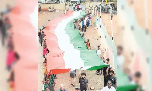 MLA Malladi Vishnu, District Collector S Dilli Rao and students participating in a rally carrying 125 feet long National Flag in Vijayawada on Monday on the 125th birth anniversary of Alluri Sitarama Raju	Photo: Ch Venkata Mastan