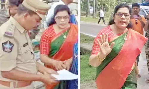 Former Union minister, K Kruparani verifying list of leaders at helipad in presence of police officer