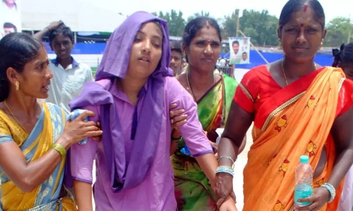 A fainted student being carried by women in Srikakulam