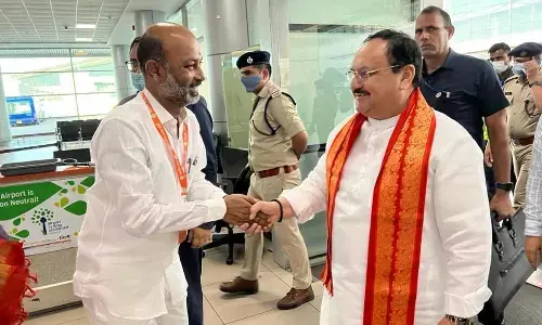 BJP State chief Bandi Sanjay receiving BJP president JP Nadda at Shamshabad airport on Thursday