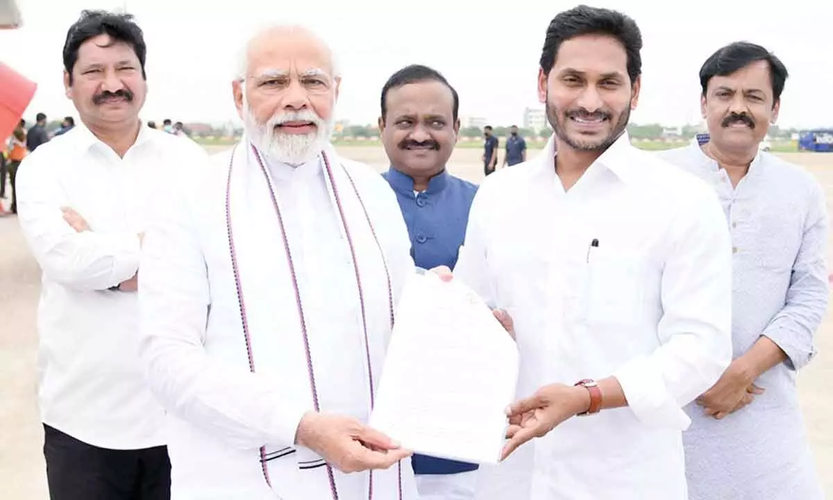 Chief Minister Y S Jagan Mohan Reddy submits a memorandum to Prime Minister Narendra Modi on issues related to AP at Gannavaram airport on Monday