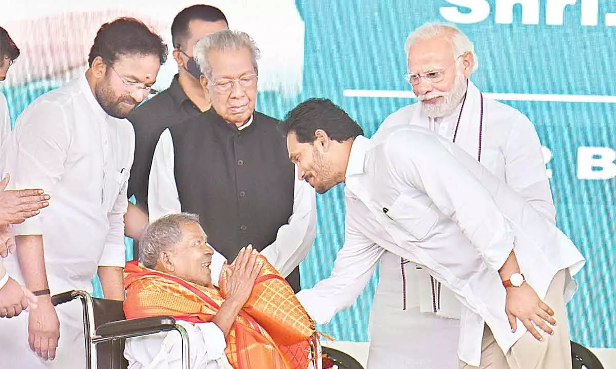 Prime Minister Narendra Modi felicitating Bodi Dora, grandson of Mallu Dora, close lieutenant of Alluri Sitarama Raju, at Peda Amiram in West Godavari district on Monday