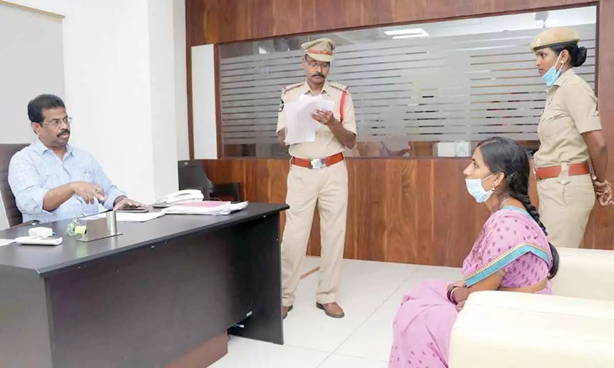 Special Branch DSP M Ambika Prasad receiving petitions from people during Spandana programme at SP office in Kakinada on Monday