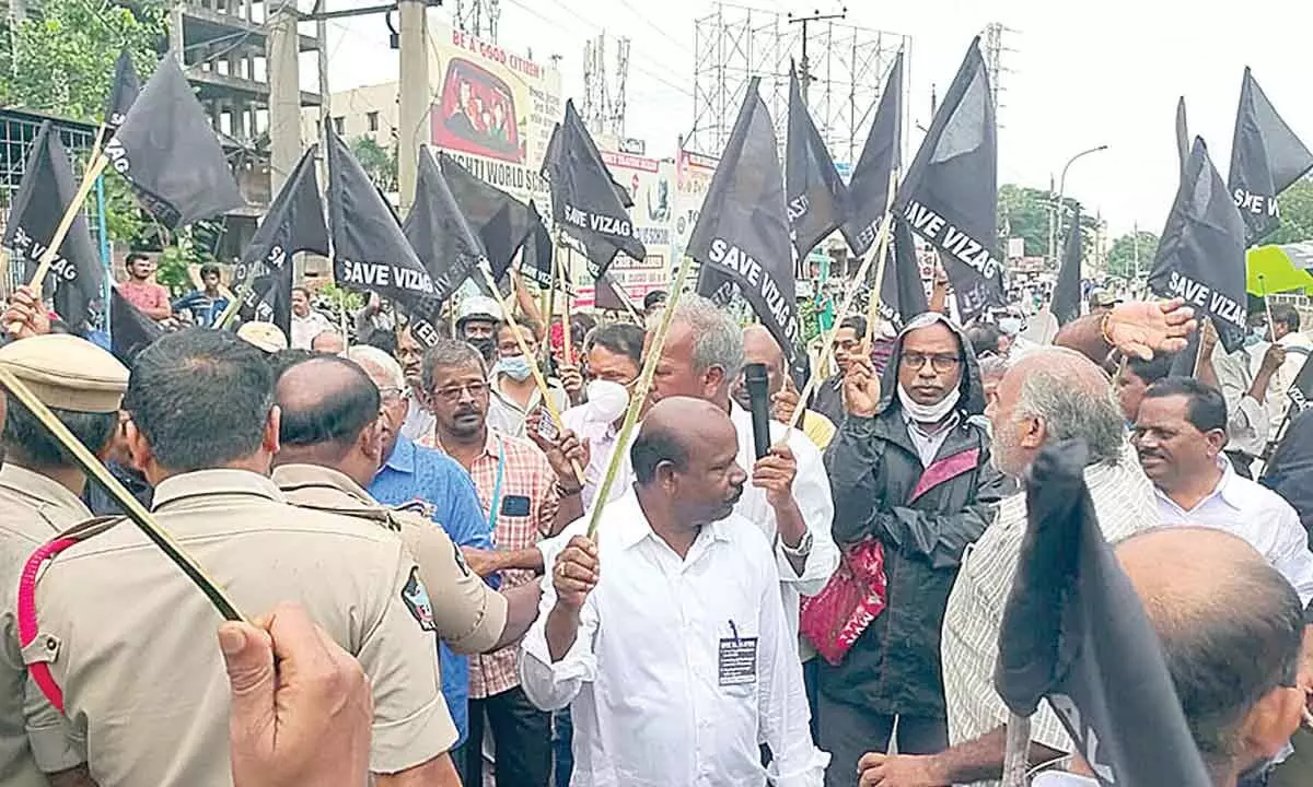 The VSP employees and trade union leaders staging a protest by holding black flags in Visakhapatnam on Monday