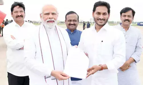 Chief Minister Y S Jagan Mohan Reddy submits a memorandum to Prime Minister Narendra Modi on issues related to AP at Gannavaram airport on Monday