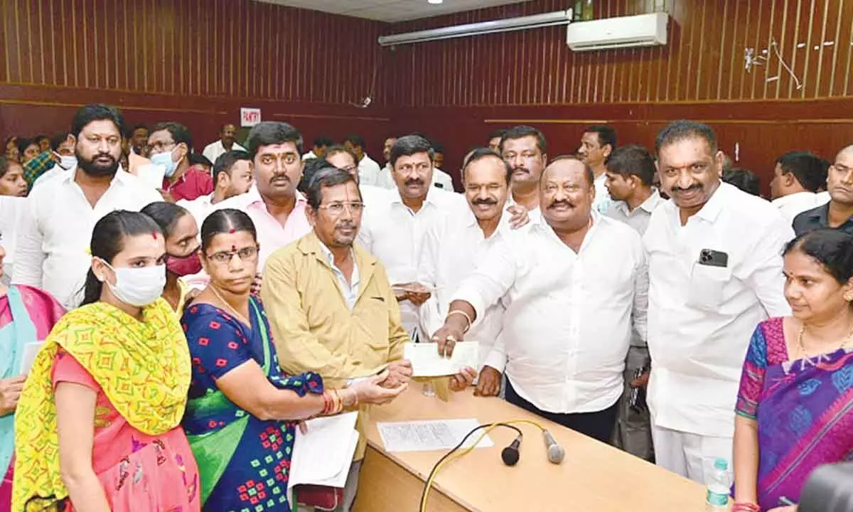 Minister G Kamalakar distributing Kalyana Lakshmi cheques to beneficiaries in Karimnagar on Tuesday