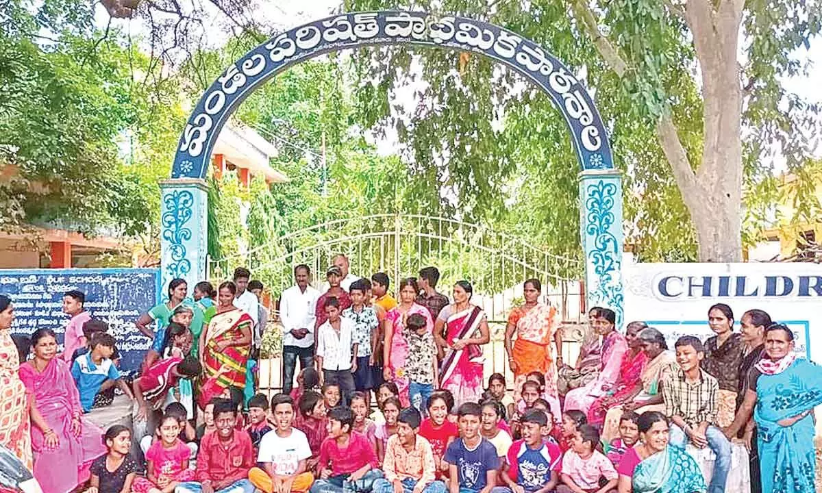 Students and their parents staging a protest in front of ZPHS in Peda Ullagallu on Tuesday