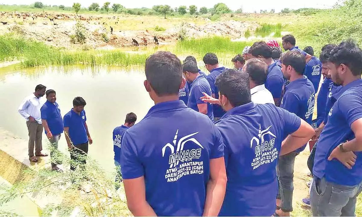 Agri dealers at the field training near a farm pond in Anantapur