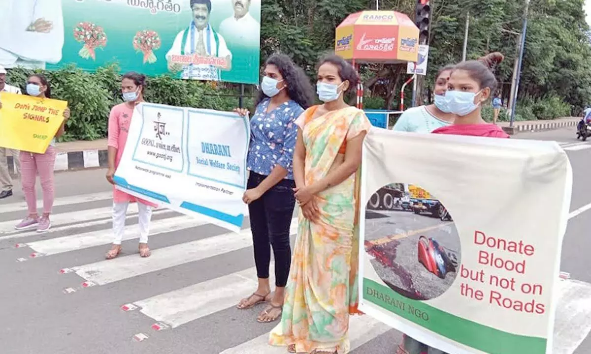 Displaying banners, transgender persons create traffic awareness in Visakhapatnam on Wednesday