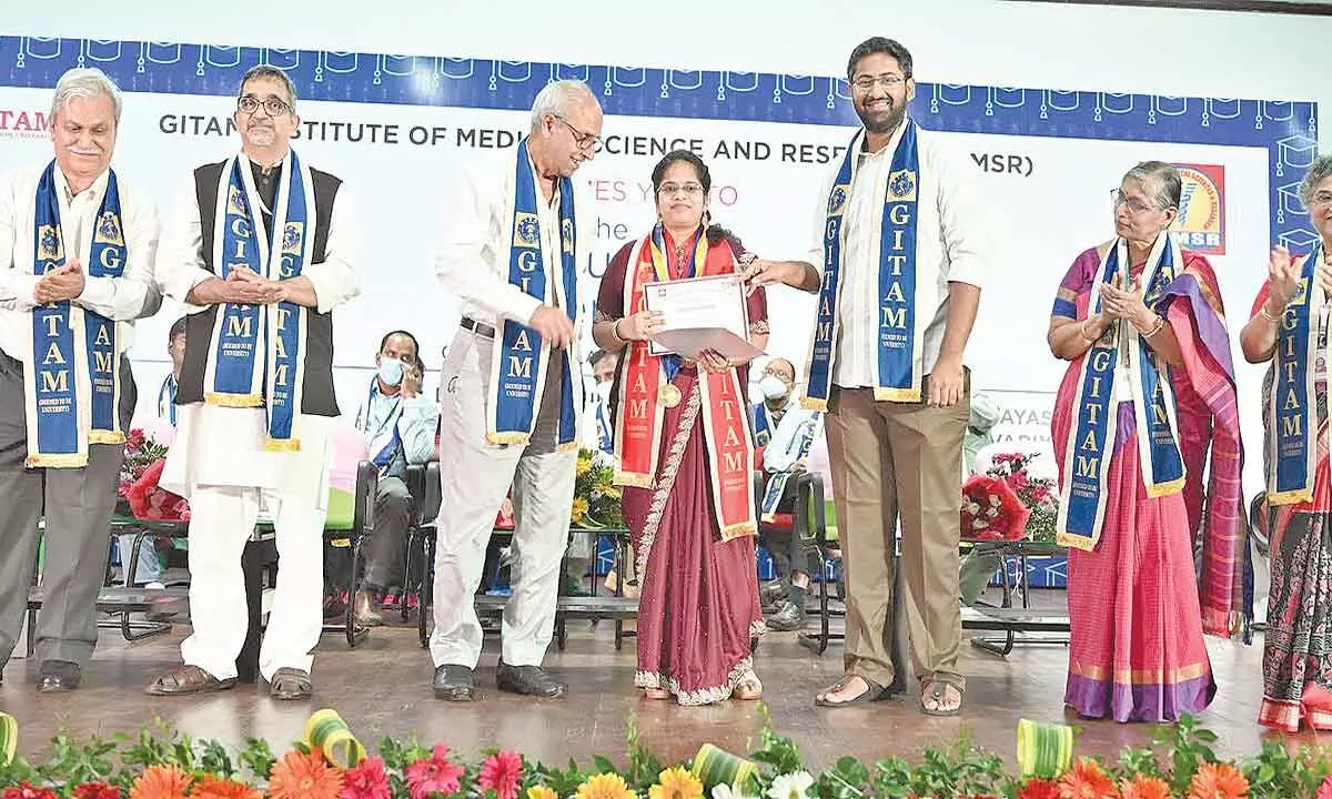 GITAM president M Sribharath awarding certificate to an MBBS graduate at the graduation ceremony held at the campus in Visakhapatnam on Friday