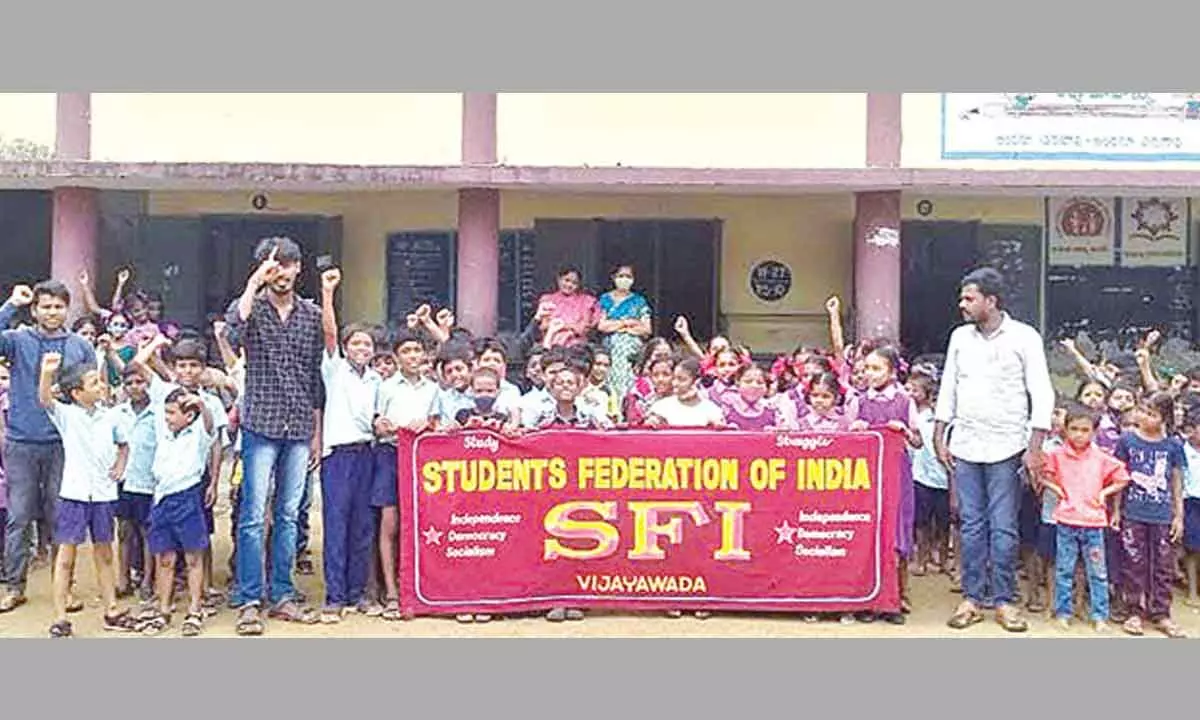 SFI leaders and students staging a protest in front of T Venkateswara Rao Municipal Corporation School in Vijayawada on Friday