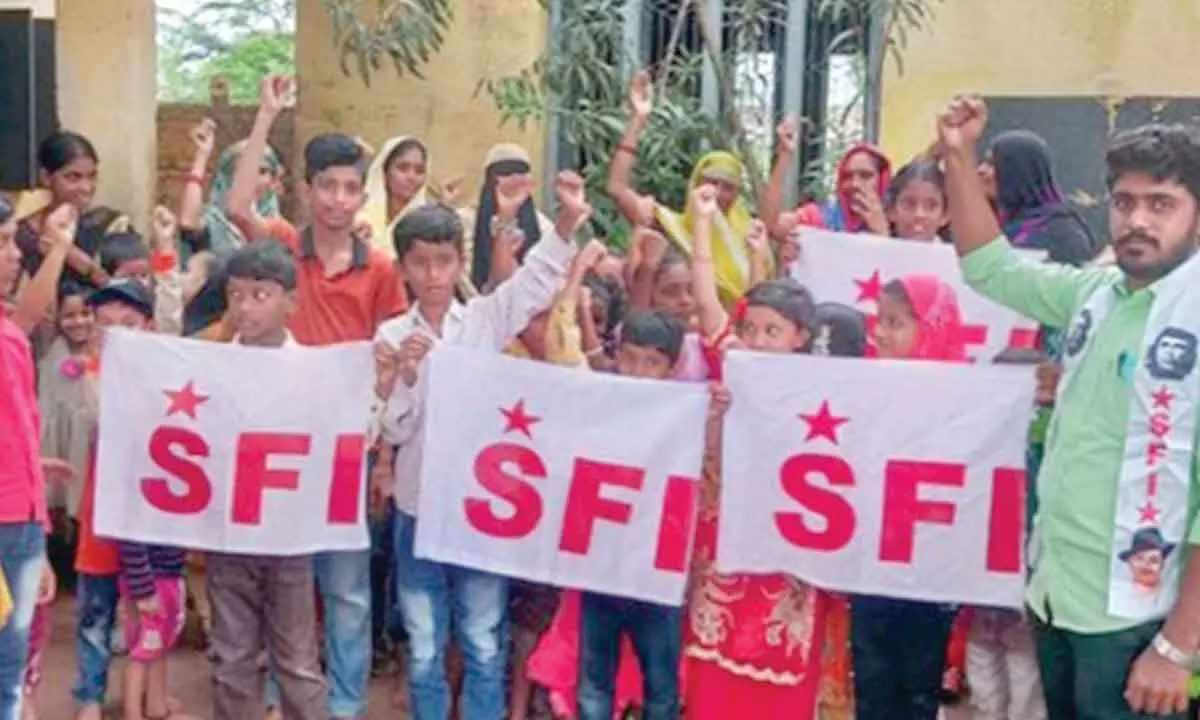 SFI district leader Dinesh Kumar along with students and parents staging a protest in Atmakur on Friday