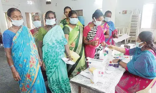 Patients at a free medical camp at Vanapamula village on Friday