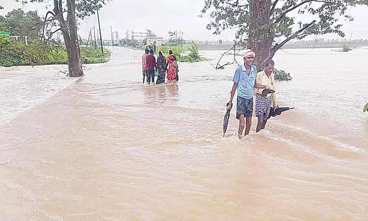 Overflowing flood water blocking traffic at Keshavpur main road in Bhupalapalli district