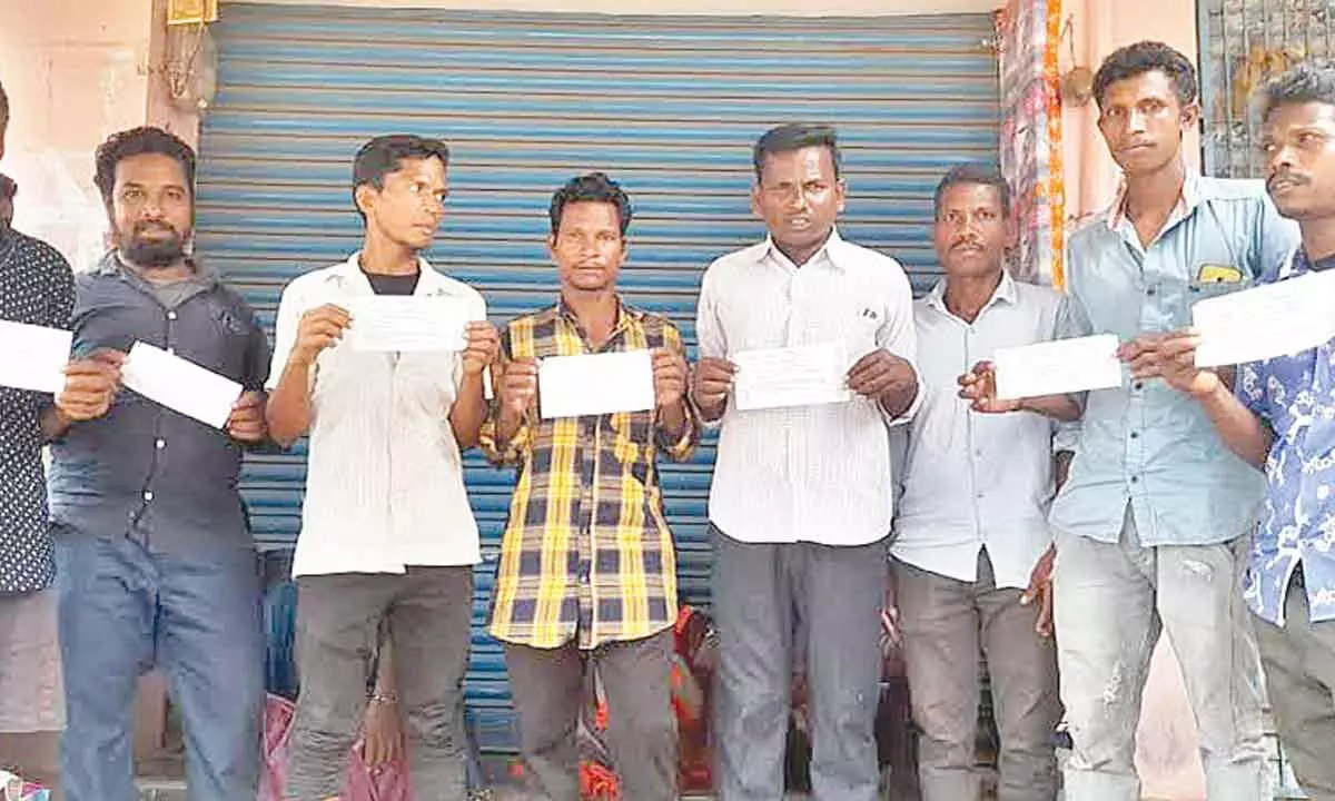 Tribals show receipts of applications submitted for their childrens caste certificates in Anakapalli district on Sunday