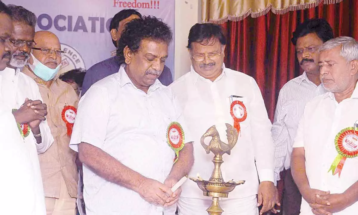 MLC KS Lakshmana Rao lighting the lamp to inaugurate a workshop on education at Andhra Loyola College in Vijayawada on Sunday