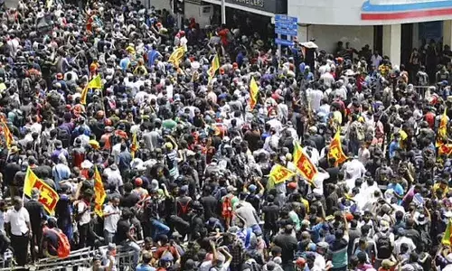Protesters carrying Sri Lankan flags gathered outside the presidents office in Colombo, Sri Lanka. (Photo | AP)