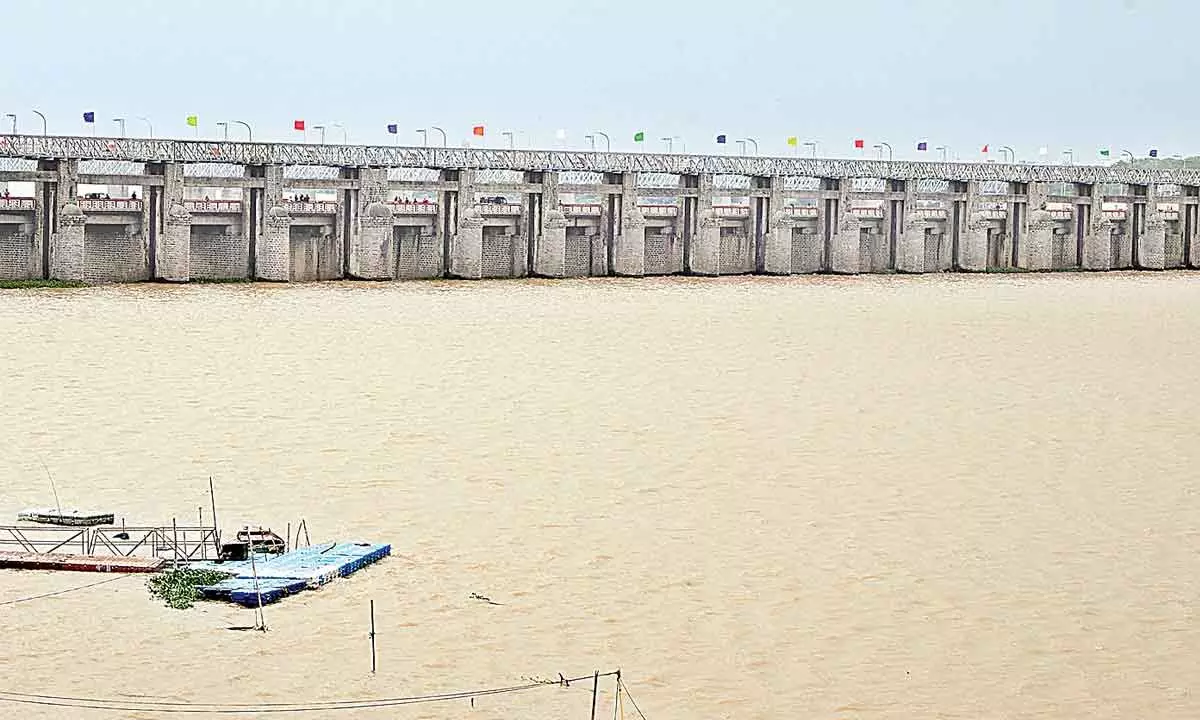 Floodwater released at Prakasam barrage in Vijayawada on Monday. 	 Photo: Ch Venkata Mastan