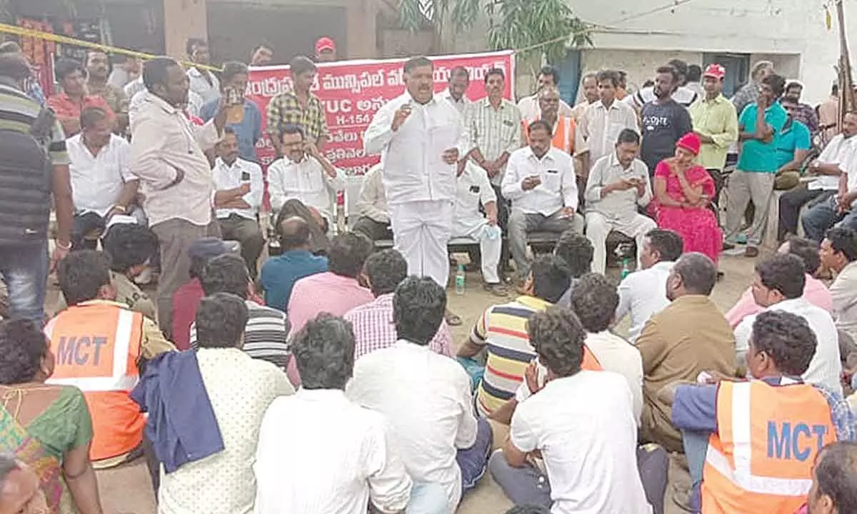 CPI district secretary Murali addressing the agitating municipal outsourced workers at municipal office in Tirupati on Monday.