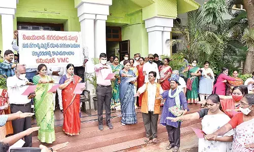 VMC Mayor Rayana Bhagyalakshmi, Commissioner Swapnil Dinkar Pundkar and other officials taking pledge at VMC office in Vijayawada on Monday