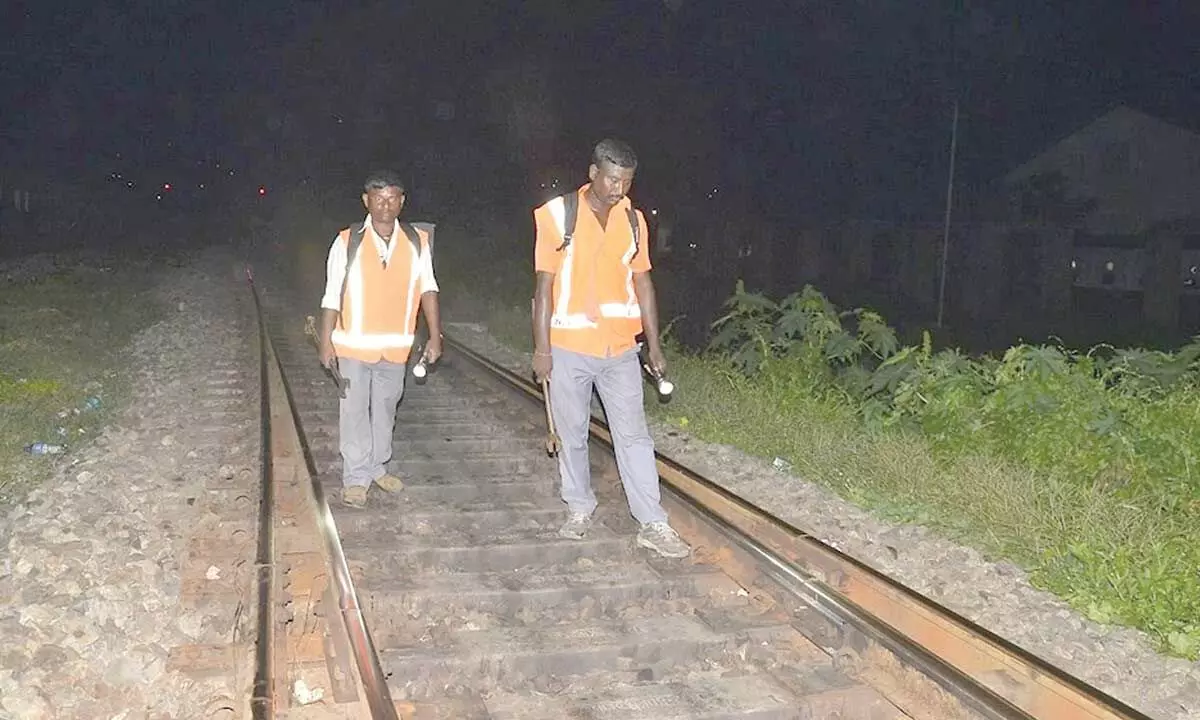 Watchmen monitoring a railway track for water levels
