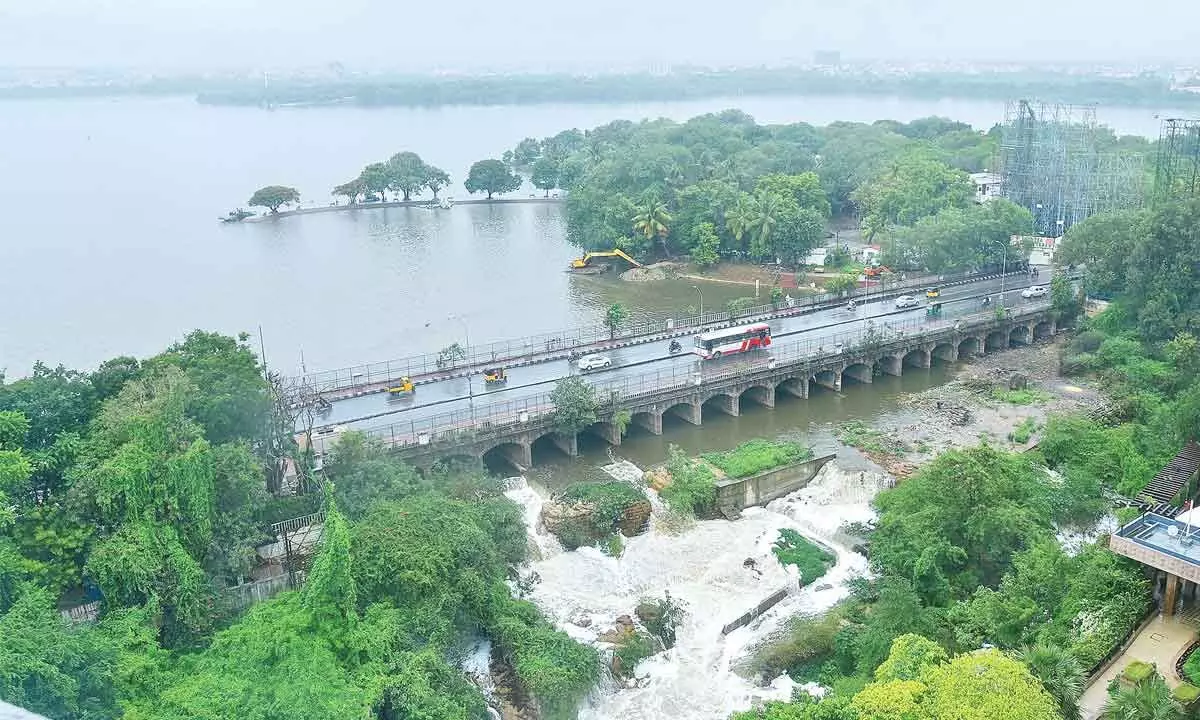 As inflows to the Hussain Sagar are increasing due to incessant rains during the past five days, the lake gates were opened letting out floodwaters on Tuesday. Photo: Adula Krishna