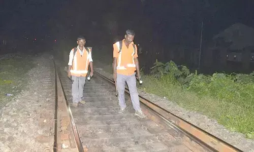 Watchmen monitoring a railway track for water levels