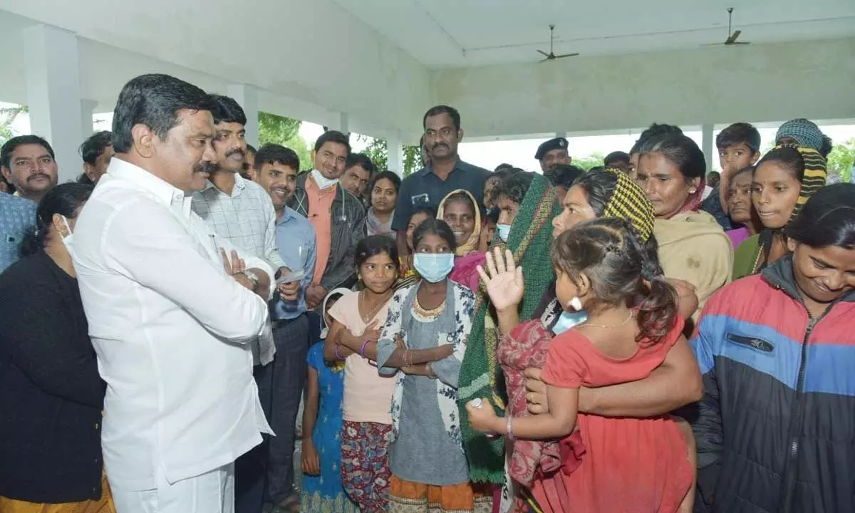 Minister Prashant Reddy interacting with flood-victims at rehabilitation centre in Nizamabad distrct on Thursday